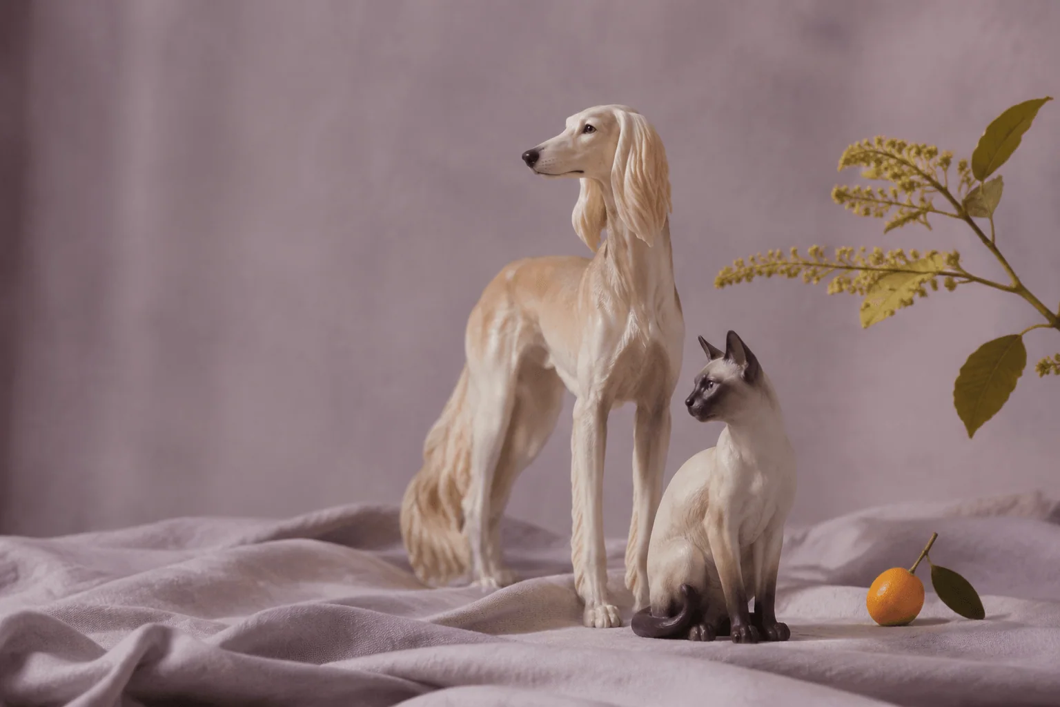 Two pet figurines in a quiet lavender-toned room